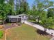 Beautiful view of the home's exterior, showcasing the lawn and driveway, complemented by surrounding trees at 4124 Dunnington Dr, Marietta, GA 30062