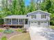 Charming home featuring a welcoming front porch, two-car garage, and beautifully landscaped front yard at 4124 Dunnington Dr, Marietta, GA 30062