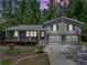 Inviting exterior view of the home with a welcoming front porch and a two-car garage at 4124 Dunnington Dr, Marietta, GA 30062