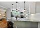 This well-lit kitchen features a breakfast bar and views into the dining area and living room at 4124 Dunnington Dr, Marietta, GA 30062