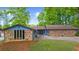 A single story home with an exterior featuring stone and blue siding surrounded by beautiful trees at 5742 Harbor Dr, Buford, GA 30518