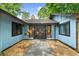 Charming home featuring a cozy entrance with a dark double door and manicured landscape at 5742 Harbor Dr, Buford, GA 30518