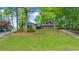 Charming single-story home featuring a stone facade, blue accents and a well manicured lawn with beautiful landscaping at 5742 Harbor Dr, Buford, GA 30518