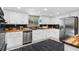 Modern kitchen with white cabinetry, butcher block counters, stainless appliances, and stylish backsplash at 5742 Harbor Dr, Buford, GA 30518