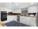 Kitchen features white cabinets, stainless appliances, wood counters, and lots of natural light at 5742 Harbor Dr, Buford, GA 30518