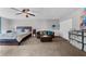 Large main bedroom with neutral paint, carpet, ceiling fan and a sitting area at 5742 Harbor Dr, Buford, GA 30518