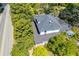 Aerial view of a home with mature trees, a dark roof, and a lush green landscape at 8612 Campbellton St, Douglasville, GA 30134