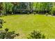 Spacious backyard featuring a well-manicured lawn with a volleyball net and mature landscaping at 8612 Campbellton St, Douglasville, GA 30134