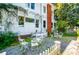 Charming backyard with outdoor seating on a gravel surface surrounded by flowering shrubs and greenery at 8612 Campbellton St, Douglasville, GA 30134