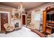 Cozy bedroom featuring a decorative fireplace, chandelier lighting, and a soft color palette at 8612 Campbellton St, Douglasville, GA 30134