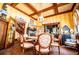 A bright dining room with striped wallpaper, hardwood floors, and vintage furnishings at 8612 Campbellton St, Douglasville, GA 30134