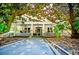 Charming two-story home featuring a classic front porch with white pillars, fans, and decorative railings at 8612 Campbellton St, Douglasville, GA 30134