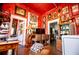 Bright red-walled kitchen featuring wooden desk, vintage stove, and colorful eclectic design at 8612 Campbellton St, Douglasville, GA 30134