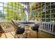 Inviting porch with lattice design, seating, and hanging chandelier offering a cozy outdoor living space at 8612 Campbellton St, Douglasville, GA 30134