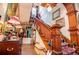 View of a staircase with hardwood banister and treads with decorative decorations and vintage furniture at 8612 Campbellton St, Douglasville, GA 30134
