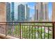 View from balcony showing steel railing and city skyscrapers beyond green trees at 1101 Juniper Ne St # 919, Atlanta, GA 30309