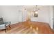 Living room with hardwood floors, a chair, and view of open kitchen at 1101 Juniper Ne St # 919, Atlanta, GA 30309
