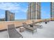 The rooftop deck provides a relaxing space to unwind and take in the cityscape with modern loungers and minimalist decor at 1101 Juniper Ne St # 919, Atlanta, GA 30309