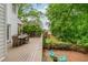 Inviting back deck with dining table and chairs, overlooking the lush backyard with a fire pit area at 1161 Arborhill Dr, Woodstock, GA 30189