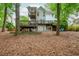 An expansive backyard with a multi-level deck and lush landscaping provides ample outdoor living space at 1161 Arborhill Dr, Woodstock, GA 30189