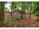 Backyard view of a multi-level deck home backing onto a lush wooded lot at 1161 Arborhill Dr, Woodstock, GA 30189