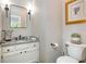 Half bathroom with granite countertops, classic fixtures, and decorative accents at 1161 Arborhill Dr, Woodstock, GA 30189