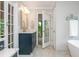 Bathroom vanity featuring marble counters, glass shower, soaking tub and bright french door to deck at 1161 Arborhill Dr, Woodstock, GA 30189