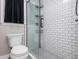 Modern bathroom with a glass-enclosed shower, white tile, and contemporary fixtures at 1161 Arborhill Dr, Woodstock, GA 30189