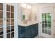 Bathroom vanity featuring bright mirror and French doors leading to bedroom and out to deck at 1161 Arborhill Dr, Woodstock, GA 30189