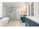 Well-designed bathroom featuring a soaking tub, glass shower, double vanity and lots of counter space at 1161 Arborhill Dr, Woodstock, GA 30189