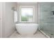 Bright bathroom showcases a soaking tub, spacious walk-in shower and a frosted window for natural light at 1161 Arborhill Dr, Woodstock, GA 30189