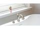 Close up on bathtub faucets shows bright, natural light from the window adding to the serene setting at 1161 Arborhill Dr, Woodstock, GA 30189