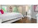 Spacious bedroom with hardwood floors, a white bed frame, and access to a private balcony at 1161 Arborhill Dr, Woodstock, GA 30189