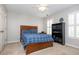 Inviting bedroom with a wood bed frame, plush carpet, and window with shutters at 1161 Arborhill Dr, Woodstock, GA 30189