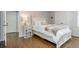 Comfortable bedroom with hardwood floors, white trim and neutral colors at 1161 Arborhill Dr, Woodstock, GA 30189