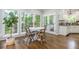 Bright breakfast nook with hardwood floors, large windows, and a view of the outdoors at 1161 Arborhill Dr, Woodstock, GA 30189