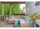 Relaxing covered patio with comfortable wicker seating, plants, and view of the lush backyard at 1161 Arborhill Dr, Woodstock, GA 30189