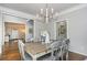 Dining room with a chandelier and view into the adjacent living room at 1161 Arborhill Dr, Woodstock, GA 30189