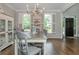 Elegant dining room with hardwood floors, stylish furniture, and natural light from shuttered windows at 1161 Arborhill Dr, Woodstock, GA 30189