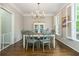 Elegant dining room with hardwood floors, stylish furniture, and natural light from shuttered windows at 1161 Arborhill Dr, Woodstock, GA 30189