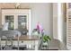 Dining room featuring white cabinet with glass doors, gray chairs, and a window with white shutters at 1161 Arborhill Dr, Woodstock, GA 30189