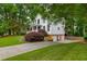 Side view of home, showing the well-manicured lawn, two-car garage, and lush trees surrounding the property at 1161 Arborhill Dr, Woodstock, GA 30189