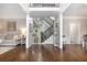 Bright foyer with hardwood floors, staircase, and a view into the living and dining spaces at 1161 Arborhill Dr, Woodstock, GA 30189