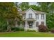 Charming two-story home boasts a welcoming front porch and professionally landscaped yard at 1161 Arborhill Dr, Woodstock, GA 30189