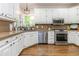 Bright kitchen with white cabinetry, stainless appliances, and stylish countertops at 1161 Arborhill Dr, Woodstock, GA 30189