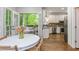 Dining nook with a view of the modern kitchen featuring stainless steel appliances and white cabinets at 1161 Arborhill Dr, Woodstock, GA 30189