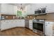 Charming kitchen with stainless appliances, hardwood floors, and natural light at 1161 Arborhill Dr, Woodstock, GA 30189
