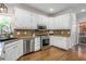Well-maintained kitchen featuring white cabinets, stainless steel appliances, and hardwood flooring at 1161 Arborhill Dr, Woodstock, GA 30189