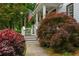 Beautiful landscaping of the property, with a variety of bushes and mature trees surrounding the home at 1161 Arborhill Dr, Woodstock, GA 30189