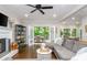 Spacious living room with fireplace, hardwood floors, and French doors leading to the outdoor deck at 1161 Arborhill Dr, Woodstock, GA 30189